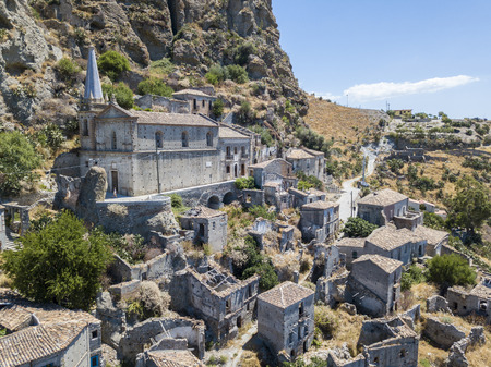 Aerial view of the village of Pentedattilo, church and ruins of the abandoned village, Greek colony on Mount Calvario, whose form recalls the five fingers, the name of the village derives from the Greekの写真素材