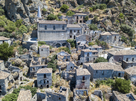 Aerial view of the village of Pentedattilo, church and ruins of the abandoned village, Greek colony on Mount Calvario, whose form recalls the five fingers, the name of the village derives from the Greekの写真素材