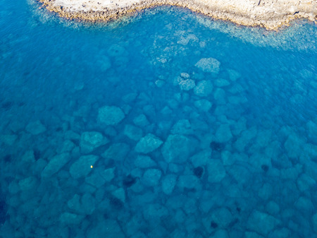 Aerial view of the rocks on the sea. Overview of the seabed seen from above, transparent waterの写真素材