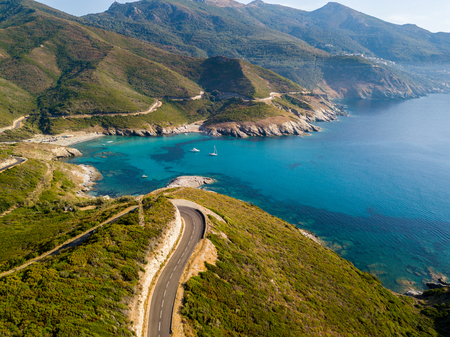 Aerial view of the coast of Corsica, winding roads and coves with crystalline sea. Cap Corse Peninsula, Corsica. Coastline. Anse d'Aliso. Gulf of Aliso. franceの写真素材