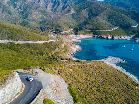 Aerial view of the coast of Corsica, winding roads and coves with crystalline sea. Cap Corse Peninsula, Corsica. Coastline. Anse d'Aliso. Gulf of Aliso. franceの写真素材