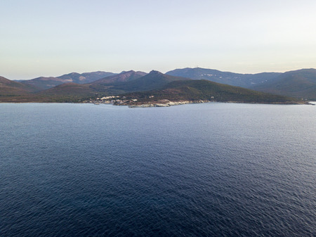 Aerial view of winding roads of the French coast. Village of Barcaggio. Cap Corse Peninsula, the northernmost point of the Cap Corse in front of the island of Giraglia. Corsica. Coastline. franceの写真素材