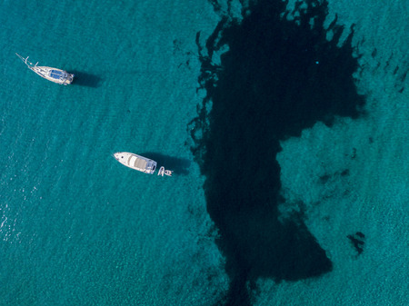 Aerial view of moored boats floating on a transparent sea. Diving relaxation and summer vacations. French Riviera, Corsica. franceの写真素材