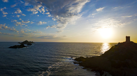 Aerial view of the Bloods Islands and the Parata Tower, the Genoese tower built in 1608, Corsica. France. Sunset over the sea on the dark red porphyry islandsの写真素材