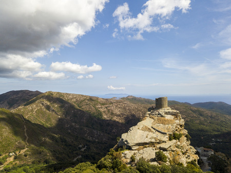 Aerial view of the Seneca Tower, Corsica, France, ancient Genoese tower of the 16th century in the heart of the Cape Corse, built as guard tower, historical monument since 1840の写真素材