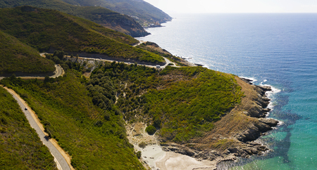 Aerial view of the coast of Corsica, winding roads and coves with crystalline sea. Cap Corse Peninsula, Corsica. Coastline. Anse d'Aliso. Gulf of Aliso. franceの写真素材