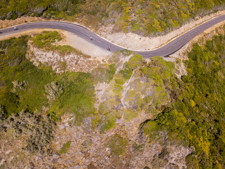 Aerial view of the coast of Corsica, winding roads. Cyclists running on a road. Peninsula of Cap Corse, Corsica. Coast line. Gulf of Aliso. franceの写真素材
