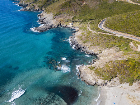 Aerial view of the coast of Corsica, winding roads and coves with crystalline sea. Cap Corse Peninsula, Corsica. Coastline. Anse d'Aliso. Gulf of Aliso. franceの写真素材