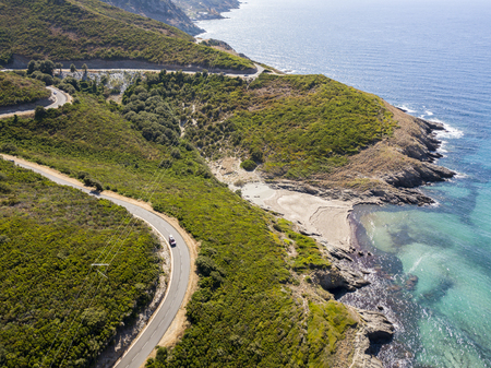 Aerial view of the coast of Corsica, winding roads and coves with crystalline sea. Cap Corse Peninsula, Corsica. Coastline. Anse d'Aliso. Gulf of Aliso. franceの写真素材