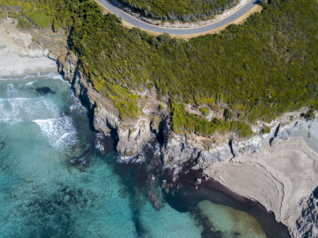 Aerial view of the coast of Corsica, winding roads and coves with crystalline sea. Cap Corse Peninsula, Corsica. Coastline. Anse d'Aliso. Gulf of Aliso. franceの写真素材