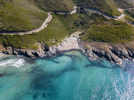 Aerial view of the coast of Corsica, winding roads and coves with crystalline sea. Cap Corse Peninsula, Corsica. Coastline. Anse d'Aliso. Gulf of Aliso. franceの写真素材