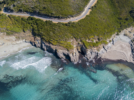 Aerial view of the coast of Corsica, winding roads and coves with crystalline sea. Cap Corse Peninsula, Corsica. Coastline. Anse d'Aliso. Gulf of Aliso. franceの写真素材