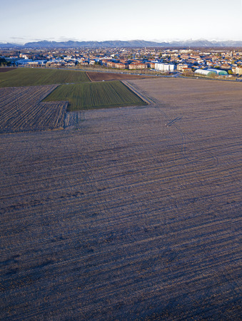 Nature and landscape, municipality of Solaro, Milano: Aerial view of a field, houses and homes, farming, grass green, countryside, farming, trees. italyの写真素材