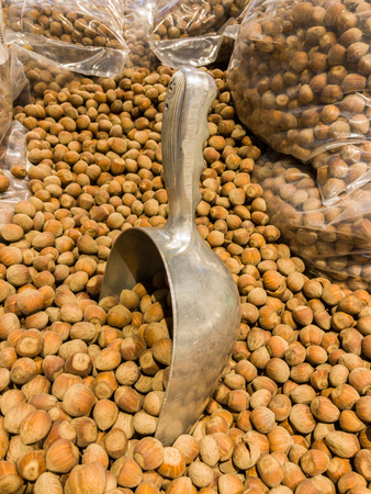 Hazelnuts, set of hazelnuts in retail. Metal scoop to collect hazelnutsの写真素材