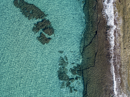 Aerial view of rocks on the sea. Seen from above, transparent waterの写真素材