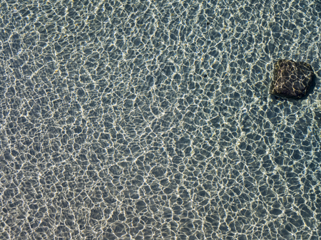 Aerial view of rocks on the sea. Seen from above, transparent waterの写真素材