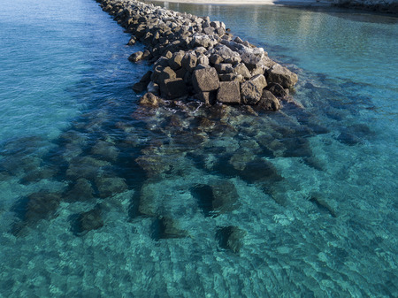 Aerial view of rocks on the sea. Seen from above, transparent waterの写真素材