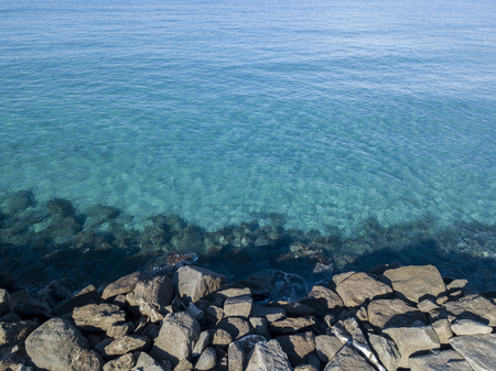Aerial view of rocks on the sea. Seen from above, transparent waterの写真素材