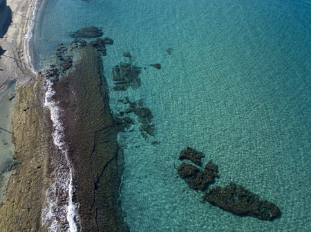 Aerial view of rocks on the sea. Seen from above, transparent waterの写真素材
