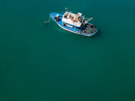 Aerial view of a fishing boat on a green sea. Vibo Marina, Calabria, Italyのeditorial素材