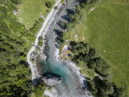 Aerial view of the giant rock called the Contessa's Bidet in the Val di Mello, a green valley surrounded by granite mountains and woods. Sondrio. Lombardy. Italyの写真素材