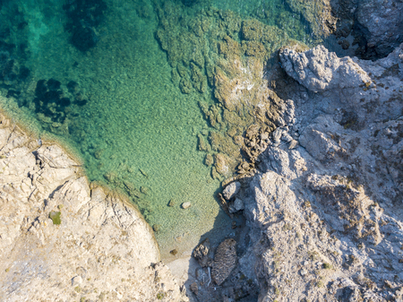 Aerial view of rocks on the sea. Seen from above, transparent waterの写真素材