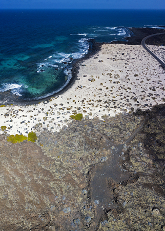Aerial view of the Spiral Caleta, spiral beach, pebbles on the ground forming a spiral. Orzola, Lanzarote, Canary Islands, Spain. Africa. Beach and rugged coastline of volcanic originの写真素材