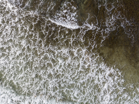 Aerial view of a crystal clear sea with waves and surfers. Playa De La Canteria. Atlantic Ocean,...