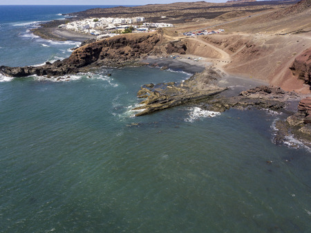 Aerial view of waves crashing on a rock formation. Playa El Golfo. Black beach of the Charco de los Clicos. Lanzarote, Canary Islands, Spainの写真素材