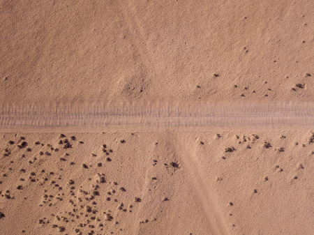 Aerial view of a desert landscape on the island of Lanzarote, Canary Islands, Spain. Road that crosses a desert. Dirt road. Formed by the crossing of off-road vehiclesの写真素材