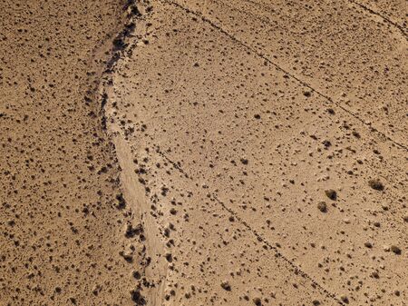 Aerial view of a desert landscape on the island of Lanzarote, Canary Islands, Spain. Desert background, texture. Sand and desolate landの写真素材