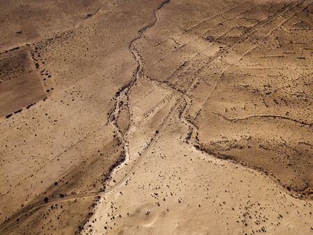 Aerial view of a desert landscape on the island of Lanzarote, Canary Islands, Spain. Desert background, texture. Sand and desolate landの写真素材