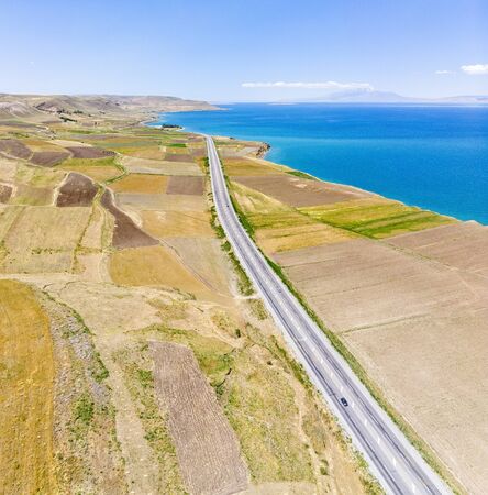 Aerial view of the lake. The largest lake in Turkey. Fields and cliffs overlooking the crystal clear waters. Roads along the lakeの写真素材