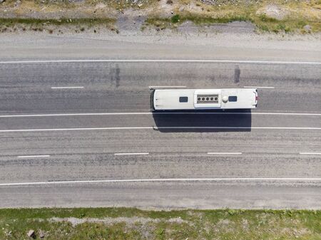 Aerial view of a high-speed road, with two lanes in each direction. Bus with a white roof. Transportation of people, travel, holidays and tourist destinations. turkeyの写真素材