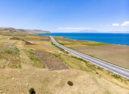 Aerial view of the lake. The largest lake in Turkey. Fields and cliffs overlooking the crystal clear waters. Roads along the lakeの写真素材