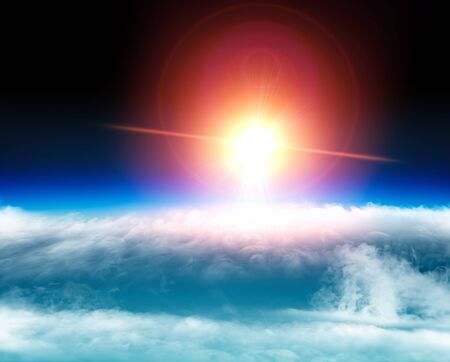 Aerial view of the sun above the clouds, space stratosphere, light and solar reflections on the clouds. Global warming, climate change. Ozone holeの写真素材