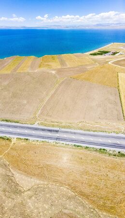 Aerial view of the lake. The largest lake in Turkey. Fields and cliffs overlooking the crystal clear waters. Roads along the lakeの写真素材
