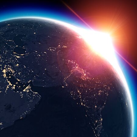 Satellite view of the Earth seen from space. The sun rising over the Middle East, India. Cities illuminated in the night. Sunriseの写真素材