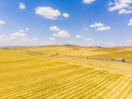 Aerial view of the road and fields near the Lake Tuz, Tuz Golu. Salt Lake. it is located in the Central Anatolia Region, Ankara, Aksaray, Konya. Highway and trucks on the streetの写真素材