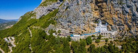 Aerial view of the Monastery of Ostrog, Serbian Orthodox Church in Ostro? Ka Greda, Montenegro. Dedicated to Saint Basil of Ostrog. Winding roadsの写真素材