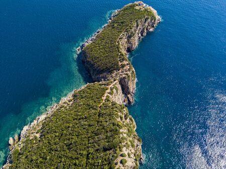 Aerial view of Sveti Nikola, Budva island, Montenegro. Jagged coasts with sheer cliffs overlooking the transparent sea. Wild nature and Mediterranean maquisの写真素材