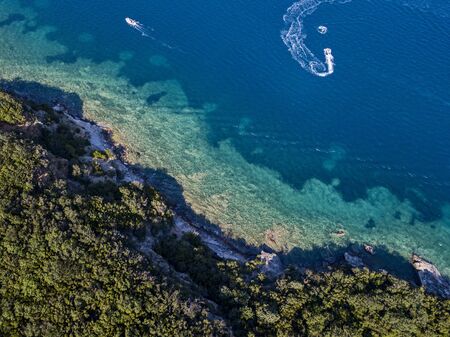 Aerial view of boats and watercraft, jagged and lush coasts. Mediterranean scrub. Sea, crystal clear water. Sveti Nikola, Budva island, Montenegroの写真素材