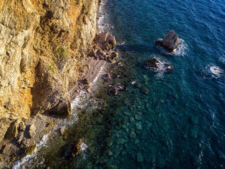 Aerial view of Buljarica headland, steep cliff on the coast lapped by crystal clear waters of the Adriatic sea. Petrovac, coastal town in Budva municipality. montenegroの写真素材