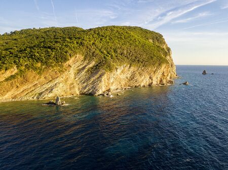 Aerial view of Buljarica headland, steep cliff on the coast lapped by crystal clear waters of the Adriatic sea. Petrovac, coastal town in Budva municipality. montenegroの写真素材