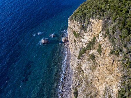 Aerial view of Buljarica headland, steep cliff on the coast lapped by crystal clear waters of the Adriatic sea. Petrovac, coastal town in Budva municipality. montenegroの写真素材