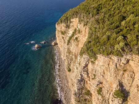 Aerial view of Buljarica headland, steep cliff on the coast lapped by crystal clear waters of the Adriatic sea. Petrovac, coastal town in Budva municipality. montenegroの写真素材