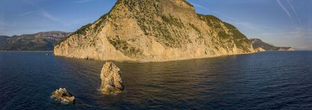 Aerial view of Buljarica headland, steep cliff on the coast lapped by crystal clear waters of the Adriatic sea. Petrovac, coastal town in Budva municipality. montenegroの写真素材