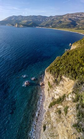 Aerial view of Buljarica headland, steep cliff on the coast lapped by crystal clear waters of the Adriatic sea. Petrovac, coastal town in Budva municipality. montenegroの写真素材