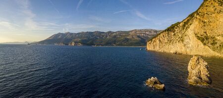 Aerial view of Buljarica headland, steep cliff on the coast lapped by crystal clear waters of the Adriatic sea. Petrovac, coastal town in Budva municipality. montenegroの写真素材