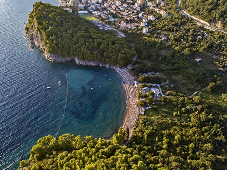 Aerial view of Petrovac and Lucice beach, one of the most beautiful sandy beaches. Umbrellas and bathers at sunset. montenegroの写真素材